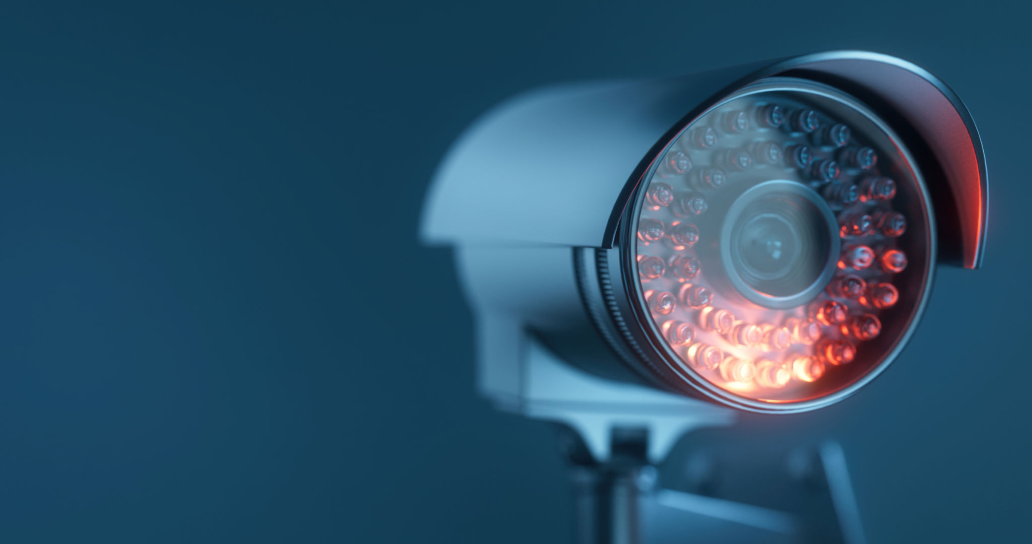 Security camera with infrared light on a dark blue background with a copy space Security camera with infrared light on a dark blue background with a copy space